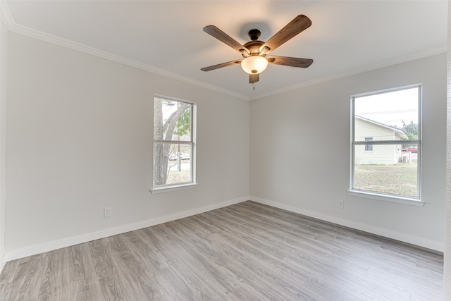 spare room featuring ornamental molding, light hardwood / wood-style flooring, and plenty of natural light