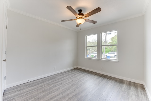 empty room featuring crown molding, light wood-type flooring, and ceiling fan