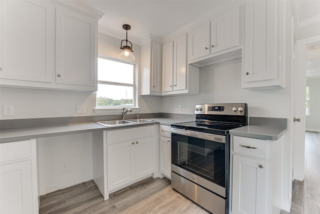 kitchen with ornamental molding, sink, light hardwood / wood-style floors, and stainless steel electric range oven