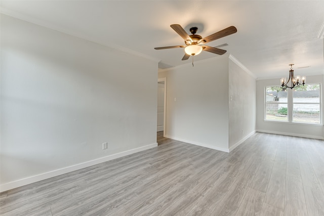 spare room featuring light hardwood / wood-style floors, crown molding, and ceiling fan with notable chandelier