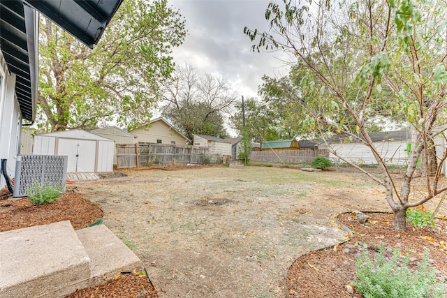 view of yard featuring cooling unit and a storage shed