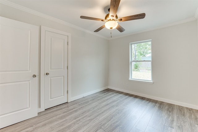 spare room featuring light hardwood / wood-style floors, ornamental molding, and ceiling fan