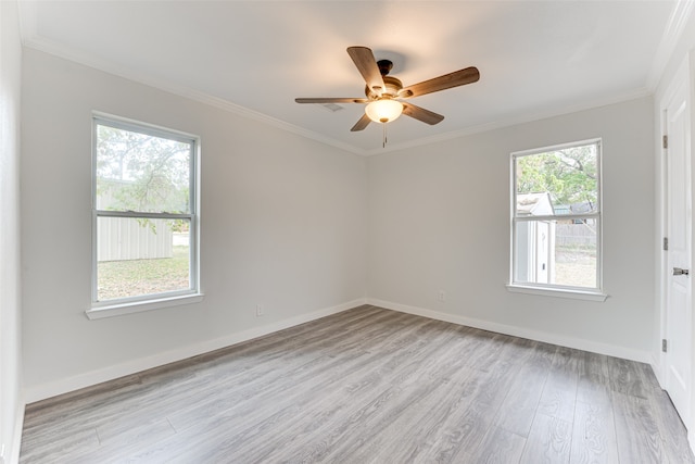 spare room featuring light hardwood / wood-style floors, ornamental molding, and ceiling fan