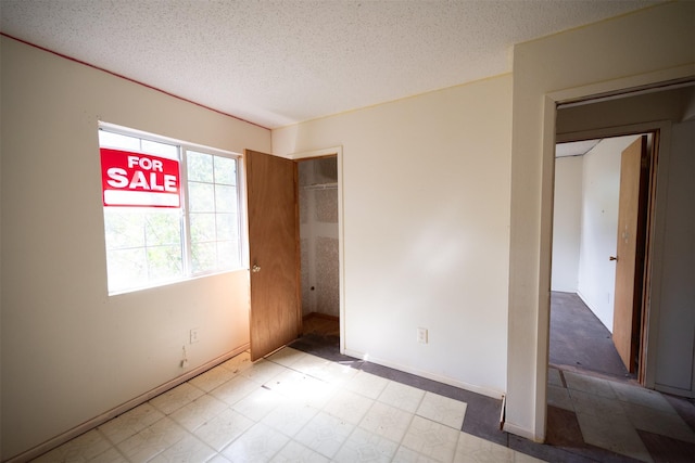 396 Fcr Unit 261, Oakwood, TX 75855 - unfurnished bedroom featuring a textured ceiling and baseboards