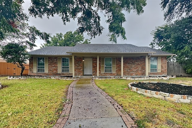 single story home featuring a front yard and covered porch