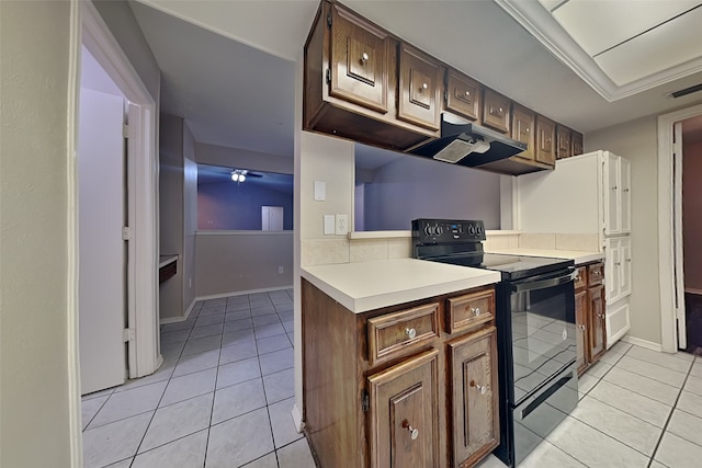 kitchen with black / electric stove, dark brown cabinetry, and light tile patterned floors