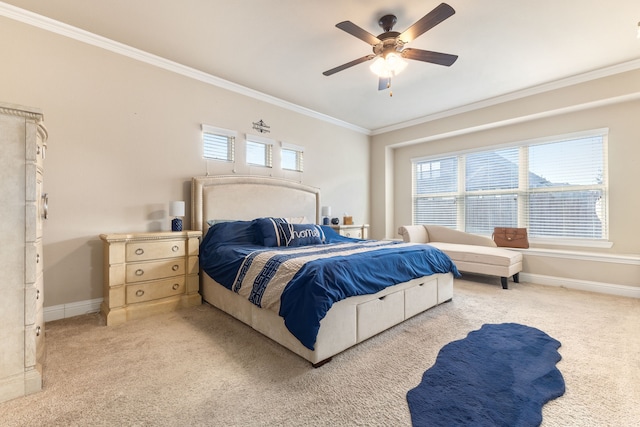 bedroom with ceiling fan, ornamental molding, multiple windows, and light colored carpet