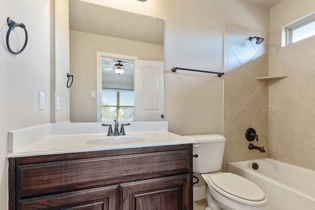 full bathroom featuring a healthy amount of sunlight, vanity, tiled shower / bath combo, and toilet