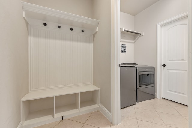 mudroom with washing machine and dryer and light tile patterned floors