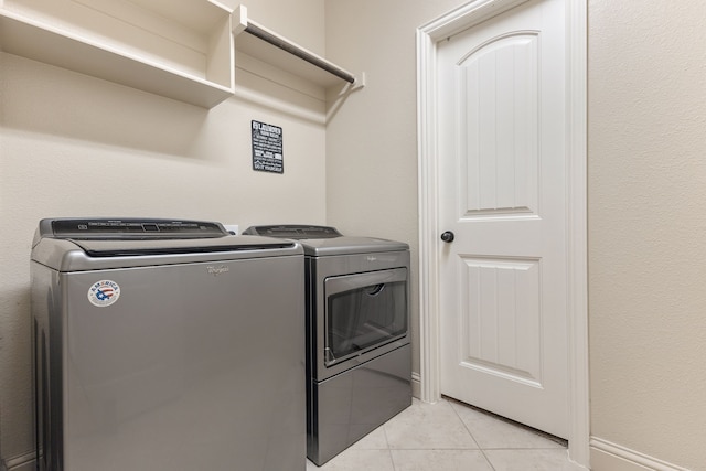 washroom with light tile patterned floors and separate washer and dryer