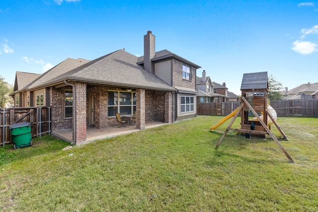 back of house with a yard, a patio, and a playground