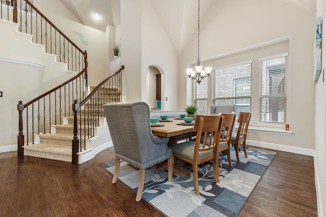 dining room featuring an inviting chandelier, dark hardwood / wood-style floors, and high vaulted ceiling