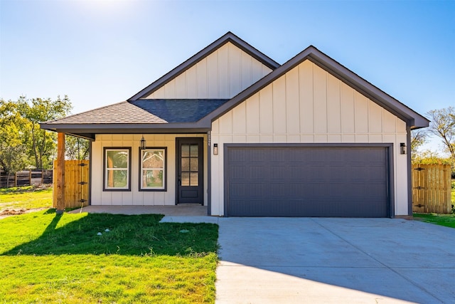 view of front of property featuring a garage and a front yard