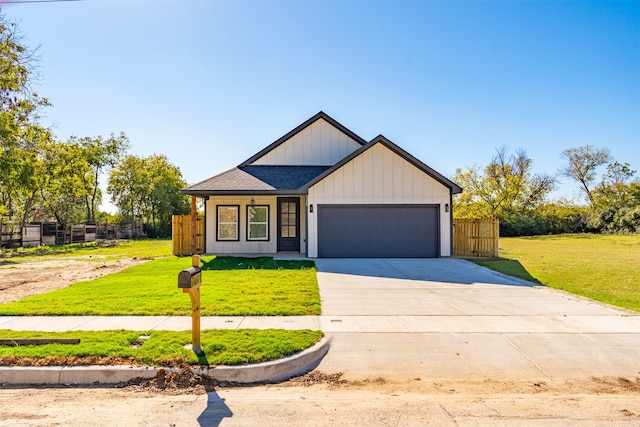 view of front of property featuring a garage and a front lawn