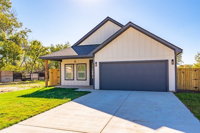 view of front of house featuring a garage and a front lawn