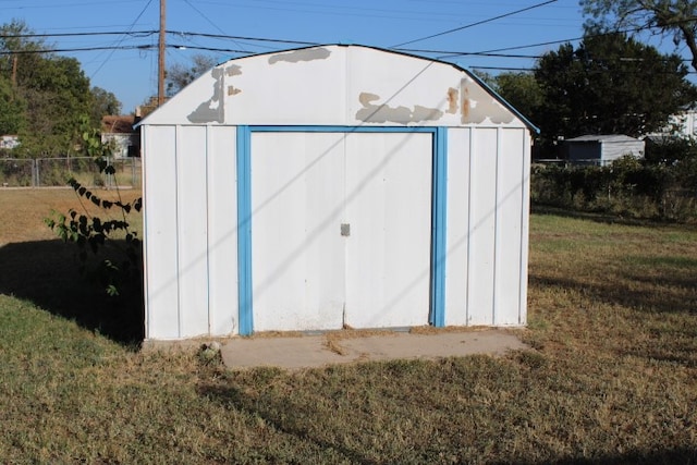 view of outbuilding with a lawn