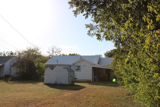 back of property with a yard and a garage