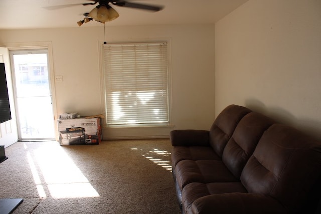 carpeted living room featuring ceiling fan