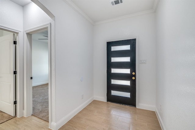 entrance foyer featuring light hardwood / wood-style flooring and ornamental molding