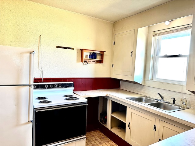 kitchen featuring white appliances and sink