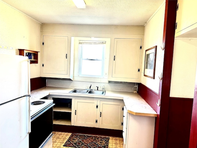 kitchen with a textured ceiling, sink, and white appliances