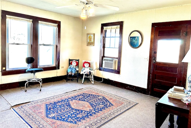 living area with ceiling fan, cooling unit, and a wealth of natural light