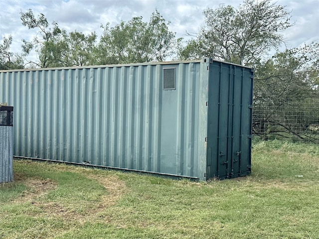 view of outbuilding with a lawn