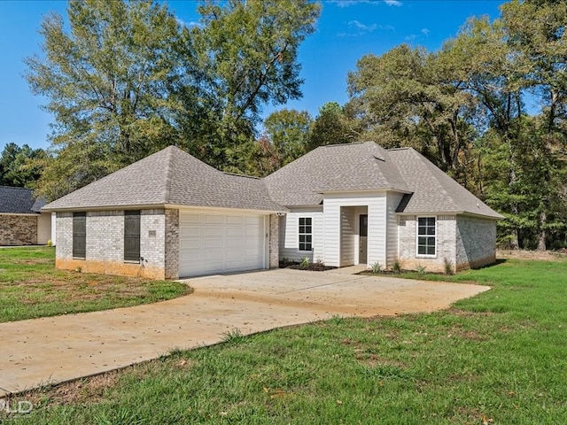 view of front of house with a front yard and a garage