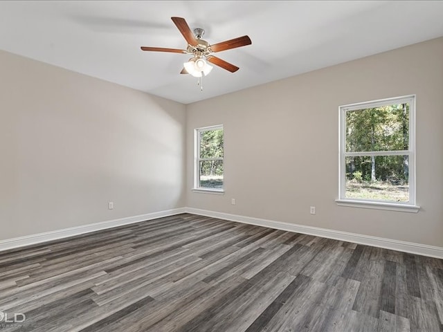 spare room with ceiling fan and dark hardwood / wood-style flooring