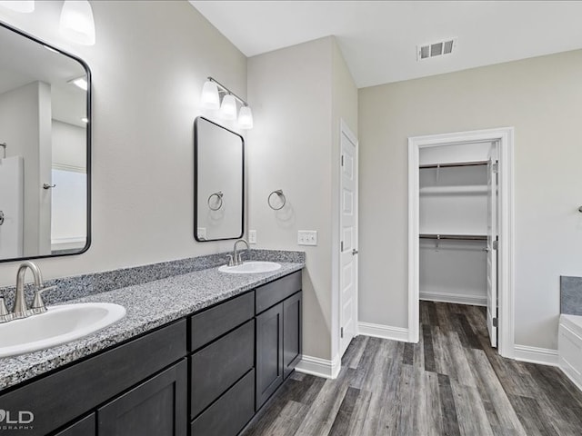 bathroom with vanity and hardwood / wood-style floors