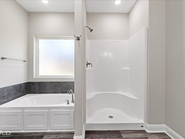 bathroom with separate shower and tub and wood-type flooring