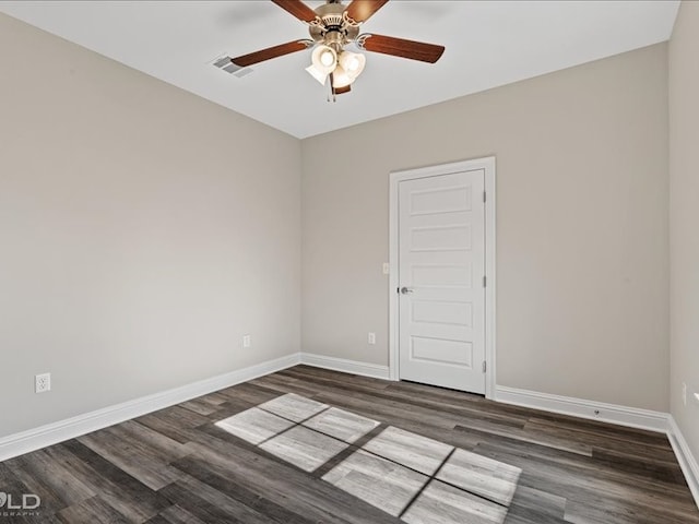 empty room with ceiling fan and dark hardwood / wood-style flooring