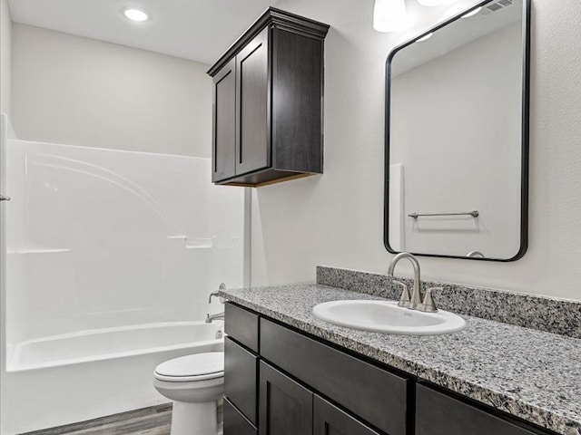 full bathroom with vanity, toilet, wood-type flooring, and shower / bathtub combination