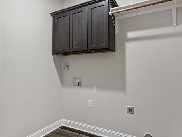 clothes washing area with hookup for a washing machine, cabinets, hookup for an electric dryer, and dark hardwood / wood-style flooring