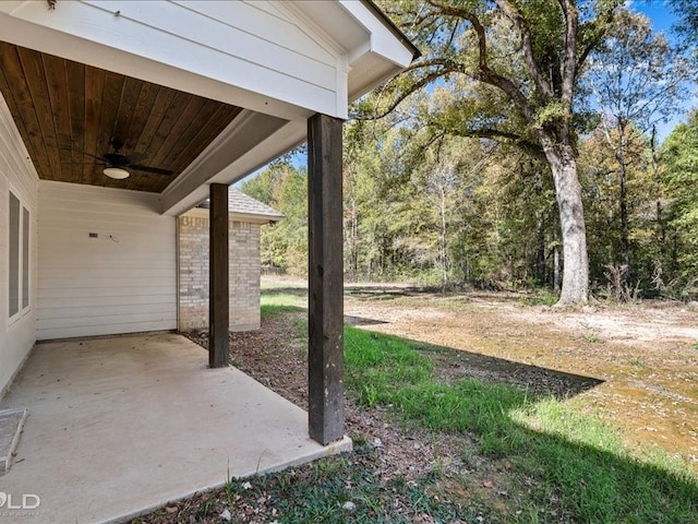 view of yard with a patio area and ceiling fan