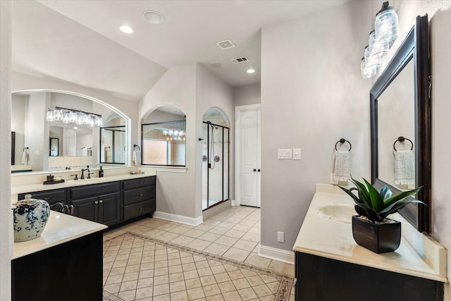 bathroom with tile patterned flooring, vanity, a shower, and lofted ceiling