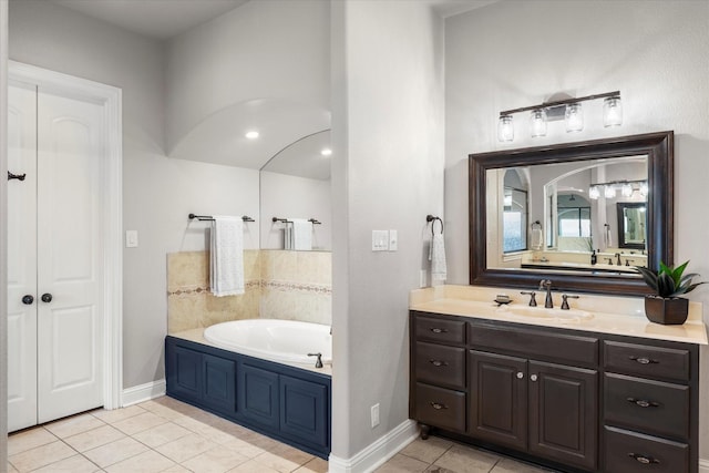 bathroom featuring tile patterned flooring, vanity, and a bathing tub