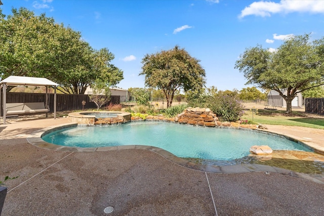 view of swimming pool with an in ground hot tub, a gazebo, and a patio area