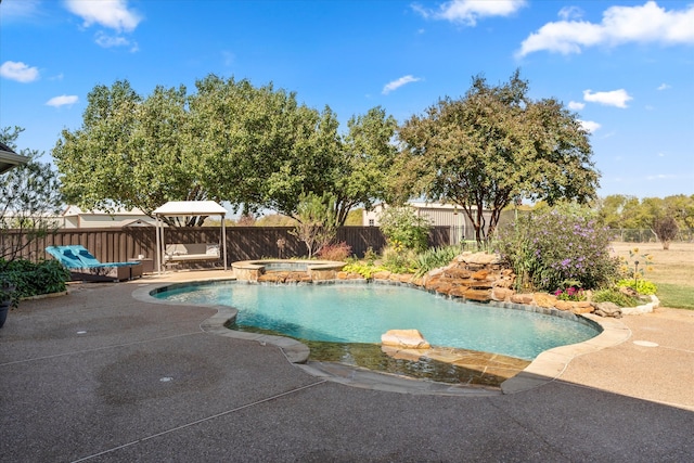 view of swimming pool with an in ground hot tub and a patio