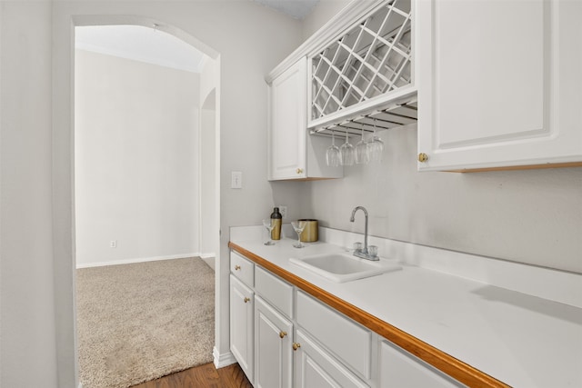 kitchen featuring sink, white cabinetry, and dark hardwood / wood-style floors