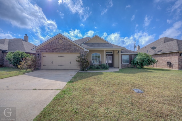 view of front of home featuring a front yard and a garage