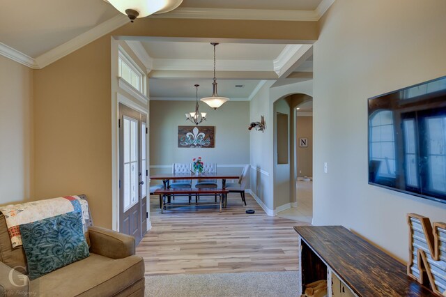 kitchen with ornamental molding, light stone countertops, kitchen peninsula, and stainless steel appliances