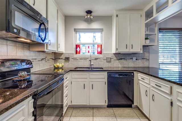 kitchen with white cabinetry, tasteful backsplash, black appliances, and sink