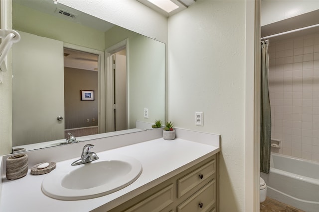 full bathroom with vanity, shower / bath combo with shower curtain, and toilet