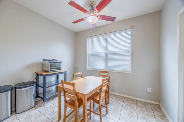 tiled dining area featuring ceiling fan