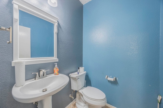 bathroom featuring sink and toilet