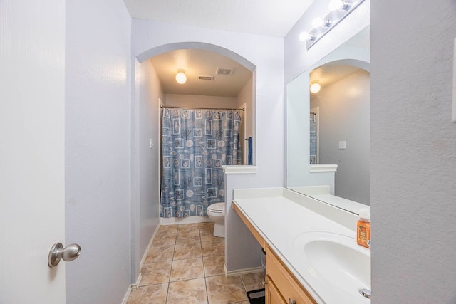 full bathroom with toilet, shower / bath combo, vanity, and tile patterned floors