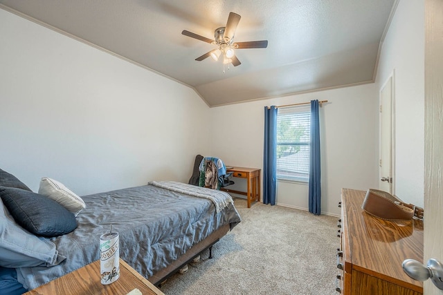 bedroom featuring ceiling fan, crown molding, vaulted ceiling, and light colored carpet