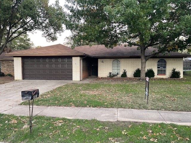 ranch-style home featuring a front yard and a garage