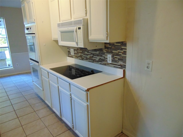 kitchen with white cabinets, white appliances, and backsplash